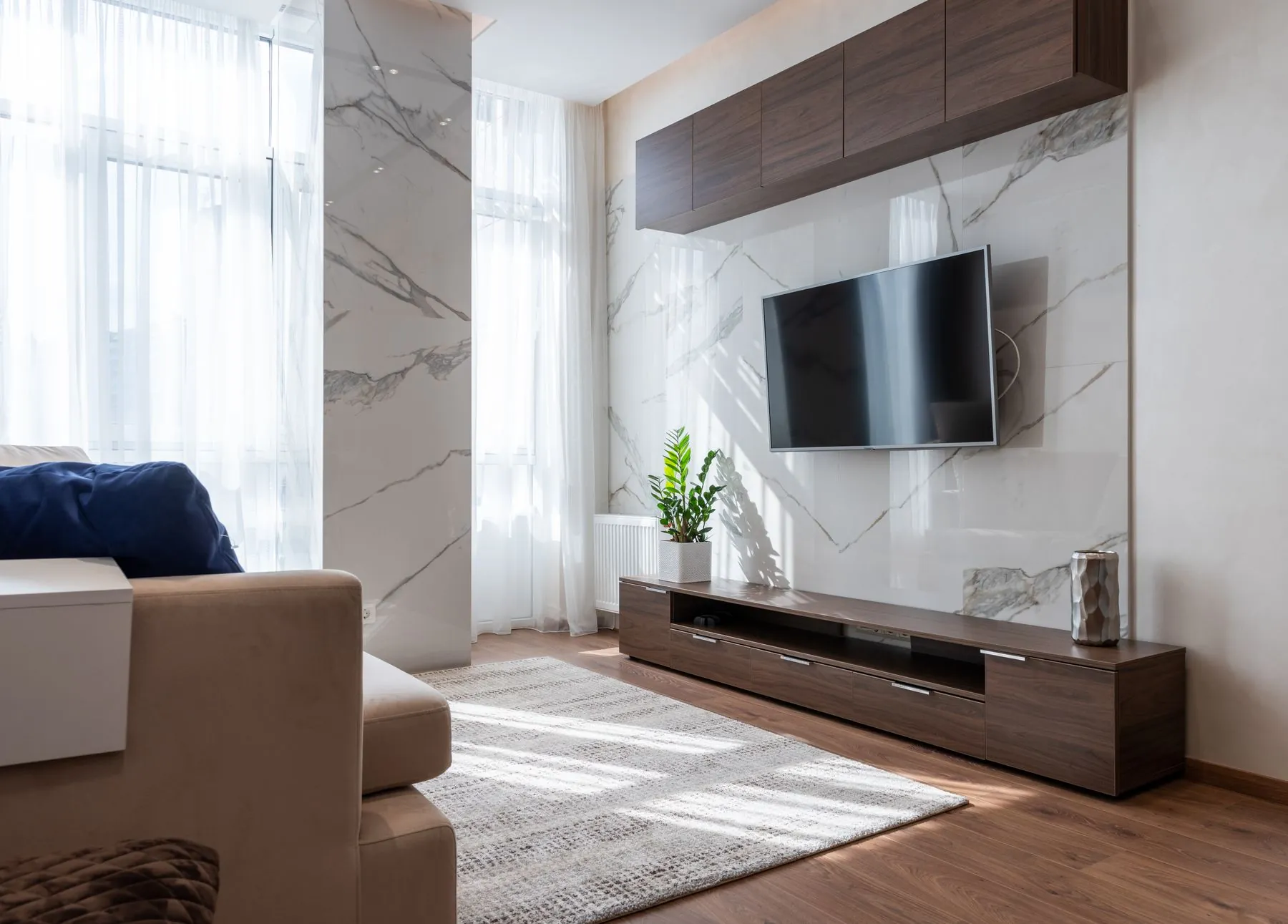 Sala com móvel de televisão e painel em pedra